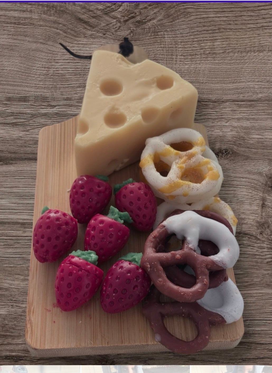 Wax melt cheese board with strawberries and chocolate pretzels